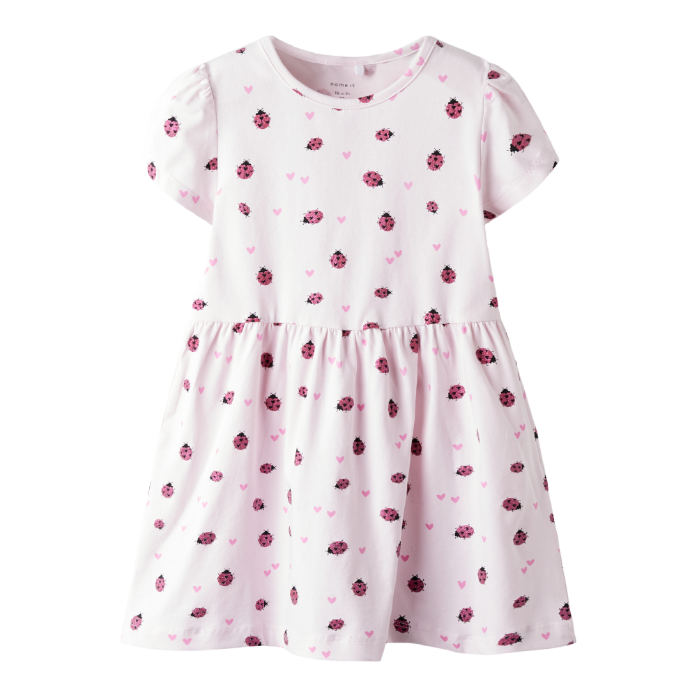 White dress with pink floral pattern on a white background