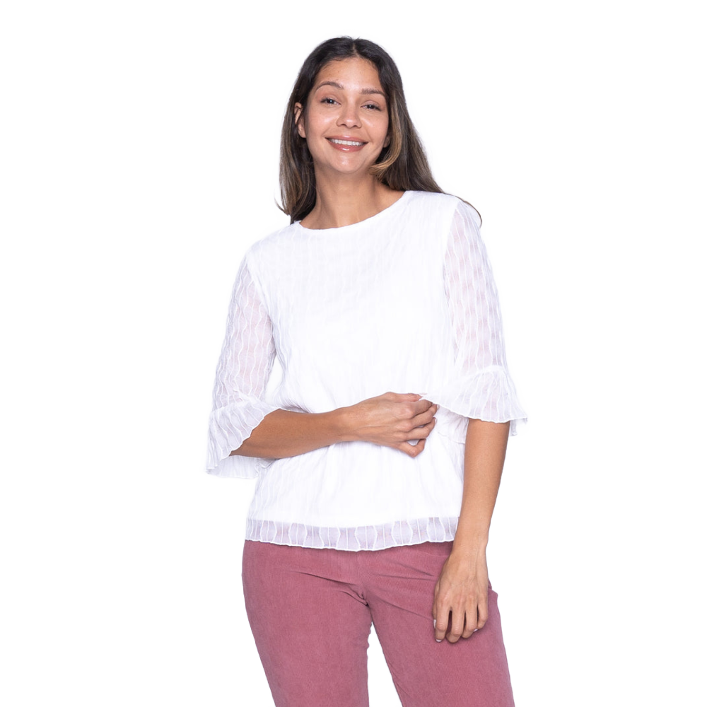 Woman wearing a white blouse with ruffled sleeves on a white background