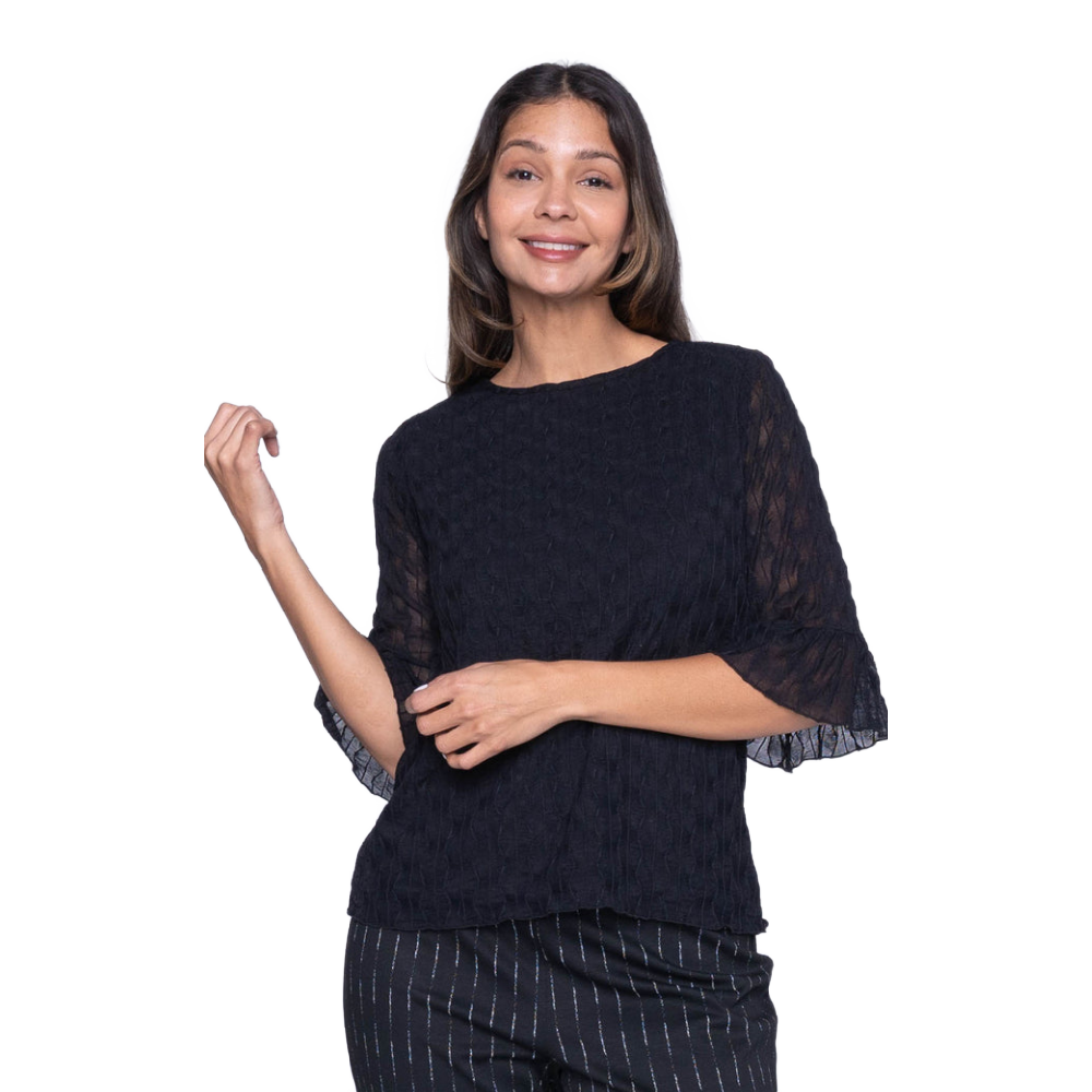 Woman wearing a black top with sheer sleeves on a white background